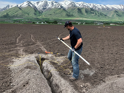 Man installing soil moisture sensors.